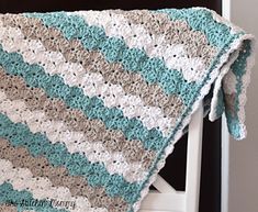 a crocheted blanket sitting on top of a chair