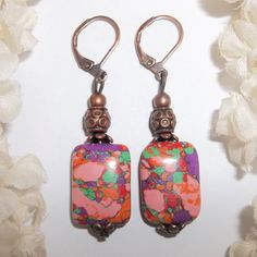 You Are Going To Love Wearing These Boho Costume Jewelry Earrings. Brand New & Handmade By Me - Wvluckygirl. Handcrafted With Bohemian Red Turkey Turquoise Stone Beads. They Have Splashes Of Red, Green, Purple, Orange, And Pink. They Also Have Rustic Antiqued Copper Toned Beads. The Pair Dangle & Drop From Lever Backs For Women's Pierced Ears. 2 Inches Tall & 1/2 Inch Wide. Each Single Earring Weighs 3.1 Grams. Very Funky And Unique! Buy Them Now Before Someone Else Does! Fashion Accessory Bold Multicolor Rectangular Jewelry For Summer, Bohemian Multicolor Dangle Plug Earrings, Bohemian Red Rectangular Earrings, Bohemian Pink Teardrop Dangle Earrings, Bohemian Orange Czech Glass Earrings, Red Bohemian Rectangular Earrings, Mauve Earrings, Multicolor Hand-strung Bohemian Earrings, Blue Pearl Earrings