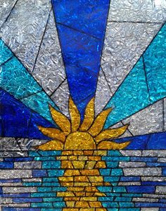 a stained glass window with a sun on it