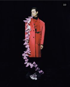 a mannequin wearing a red coat and pink flowers