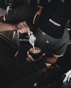 a person pouring coffee into a cup