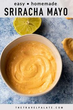 a bowl filled with homemade sriraca mayo sauce next to limes on the side