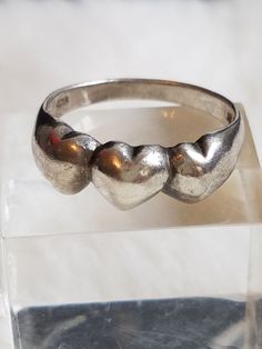 This Rare and Vintage Romantic Signed NF 925 Ring features triple hearts design and is being listed just in time for Valentine's Day. This ring is in a size 7 and is in great vintage condition. The ring will arrive in a ring box with FREE SHIPPING. Please let me know upon purchasing if you would like me to polish it for you. Adjustable Vintage Heart Ring, Vintage Silver Heart Ring For Valentine's Day, Vintage 925 Stamped Heart Ring, Vintage Heart Ring Stamped 925, Vintage Sterling Silver Heart Ring For Valentine's Day, Vintage Adjustable Heart Ring For Anniversary, Vintage Silver Rings For Valentine's Day, Adjustable Vintage Heart Ring For Anniversary, Vintage Heart Ring Stamped 925 For Valentine's Day