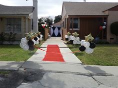 balloons and streamers decorate the front yard of a house