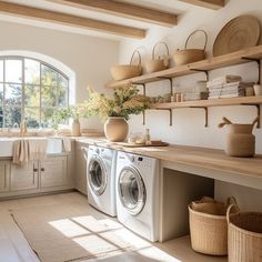 a washer and dryer in a room with open shelves