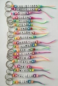 a bunch of key chains that are all different colors and sizes with words written on them