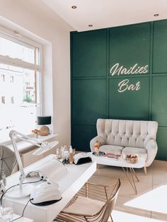 a room with green walls and white furniture