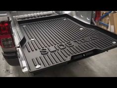 the back end of a pickup truck with an open bed and grilling area on it