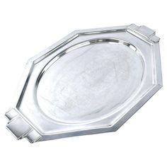 a silver tray with two handles on the bottom and one in the middle, sitting on a white surface