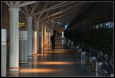 a man is walking through an airport terminal