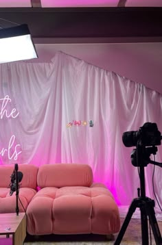 a pink couch sitting in front of a camera