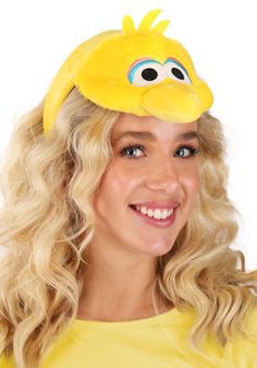 a woman with blonde hair wearing a yellow t - shirt and an angry bird hat