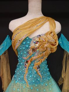 a dress with blue and gold beads on it