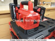 a red and black tool box sitting on top of a counter in a store with the words charger not included