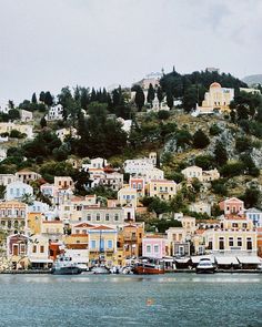 boats are parked on the water in front of houses