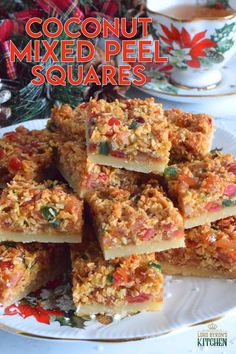 coconut mixed pecan squares on a plate with christmas decorations in the background and text overlay that reads, coconut mixed pecan squares