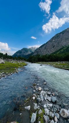 a river running through a lush green valley