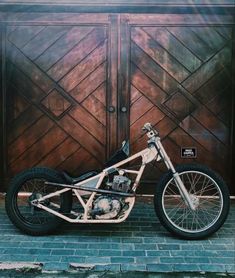 a motorcycle parked in front of a wooden door