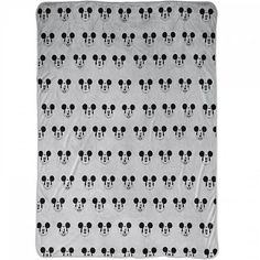 a mickey mouse blanket with black and white heads on the front, in an allover pattern