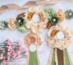 some paper flowers and ribbons on a table