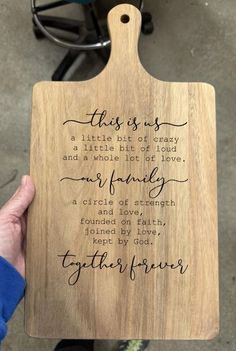 a wooden cutting board with the words, this is us in cursive writing