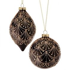 two black and gold ornaments hanging from chains