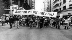 black and white photo of protestors marching down the street