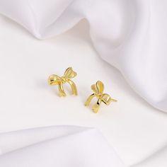 Bow Gold Stud Earrings Gold Earrings With Decorative Bow For Party, Gold Earrings With Decorative Bow As Gift, Gold Dainty Bow Earrings, Chic Gold Earrings With Decorative Bow, Cute Gold Bow Earrings, Wanderlust And Co, Clothes Shopping, Gold Stud Earrings, Colored Gems