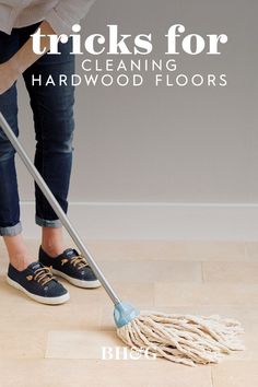 a woman is using a mop to clean hardwood floors with the words tricks for cleaning hard wood floors