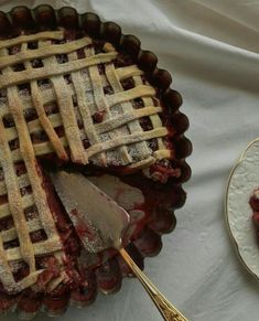 a pie on a plate with a fork next to it