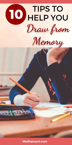 a person sitting at a desk with pencils and paper in front of them on top of