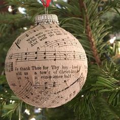 an ornament hanging from a christmas tree with musical notes on it's side