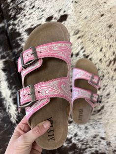 Add a pop of playful flair to your summer wardrobe with these Pink and White Blossom Glimmer Hand-Tooled Sandals. The vibrant pink magenta hue will make a statement while the supple leather and comfort sole ensure all-day comfort. Perfect for market strolls or poolside lounging, these sandals add personality to any outfit. Trendy Pink Slip-on Sandals, Spring Pink Sandals With Buckle Closure, Trendy Pink Sandals With Buckle Closure, Spring Sandals With Buckle Closure For Outings, Pink Slip-on Summer Sandals, Pink Slip-on Sandals For Summer, Pink Summer Sandals With Cushioned Footbed, Pink Sandals With Cushioned Footbed For Vacation, Pink Cushioned Sandals For Vacation