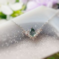 Be the best version of yourself and let your light shine with purpose and passion with our “To Bloom Again” Moss Agate White Gold Necklace. This enchanting necklace features a pear-shaped moss agate stone that sits at the heart of the silver leaves embellished with white topaz. A graceful reminder that with the right determination, nothing is beyond your means. ✦14K White Gold Vermeil (14K white gold plated over a sterling silver base) *Please be informed that your moss agate patterns are natura Moss Jewelry, Moss Agate Necklace, Moss Agate Jewelry, Moss Agate Stone, Silver Leaves, White Gold Necklace, Moss Agate Ring, Gold Vermeil Jewelry, Lucky Stone