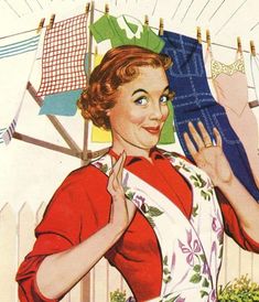 a woman is holding up clothes on a line