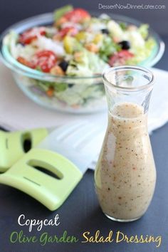 a salad in a glass bottle next to a cutting board