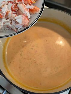 a bowl filled with soup next to another bowl full of food