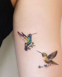 two hummingbirds on the side of a woman's thigh