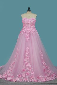 a pink wedding dress with flowers on it