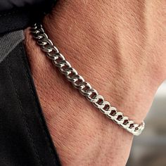 This alluring rhodium-plated sterling silver curb chain bracelet is given a refined touch with a gleaming rhodium plating that ensures longevity and a brilliant shine. Whether worn solo or stacked with other bracelets, this striking piece is a perfect style staple for the contemporary man. Everyday Silver Cuban Link Bracelet, Classic Stainless Steel Bracelet With Curb Chain, Classic Stainless Steel Curb Chain Bracelet, Classic White Gold Cuban Link Bracelet For Everyday, Classic Everyday Cuban Link Bracelet In White Gold, Classic Sterling Silver Curb Chain Bracelet For Everyday, White Gold Cuban Link Chain Bracelet, Everyday Silver Curb Chain Bracelets, Classic White Gold Cuban Link Bracelet With Curb Chain