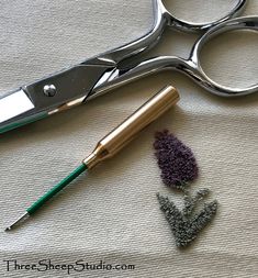 a pair of scissors and some beads on a table