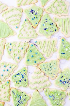 green and blue decorated cookies on a white surface