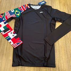 a black shirt with flags on the sleeves