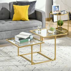 a living room scene with focus on the coffee table and two end tables that have books on them