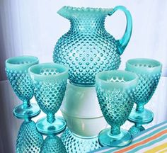 a set of blue glassware sitting on top of a table