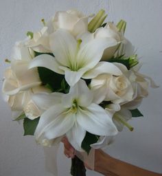 a person holding a bouquet of white flowers