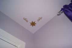 the ceiling is painted purple and has gold designs on it