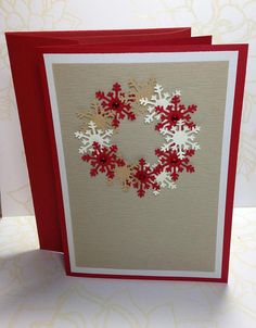 a card with red and white snowflakes on it