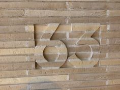 a brick wall with the number fifty five carved into it