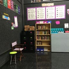 a classroom with black walls and lots of books